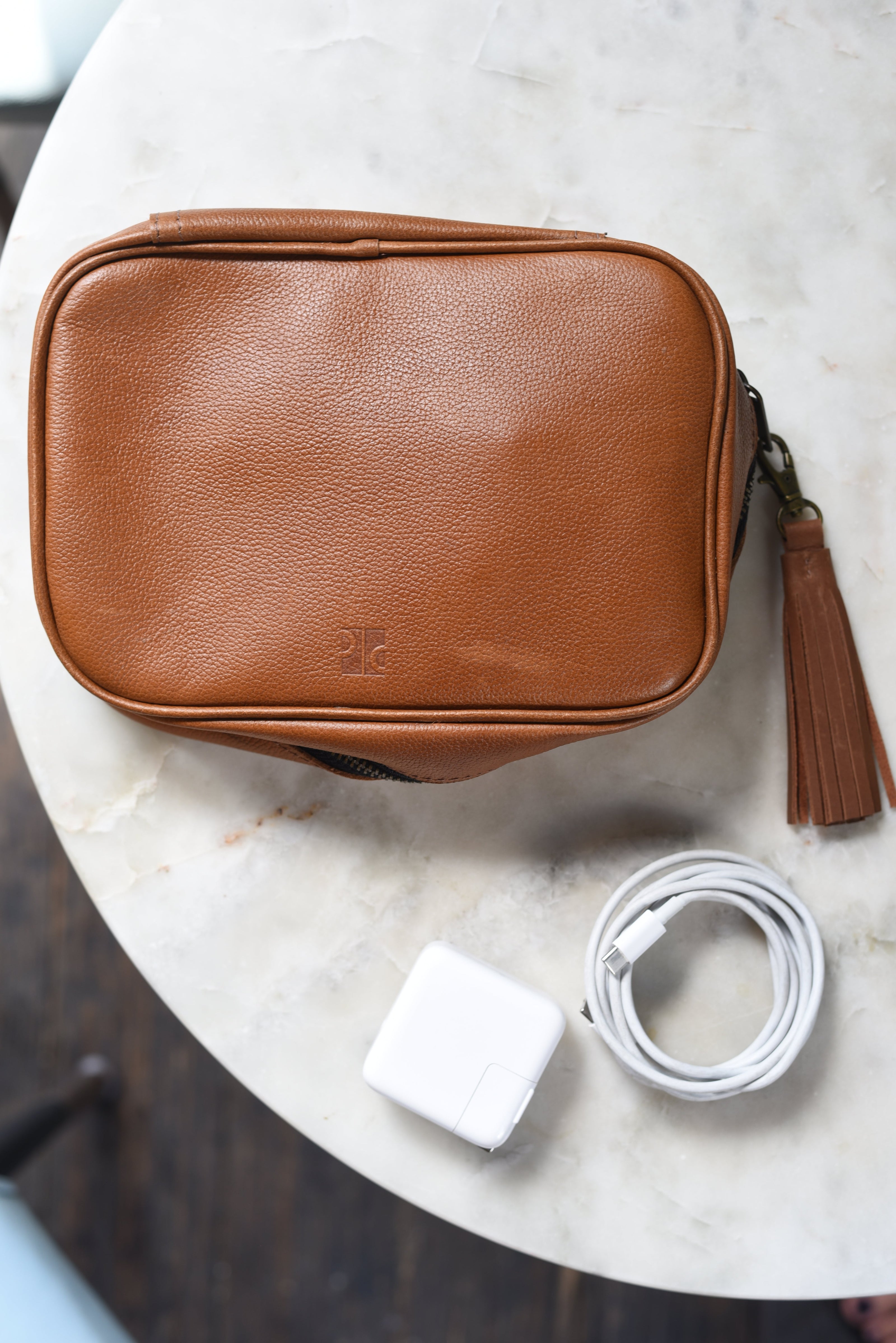 Brown leather organizational pouch with leather tassel 